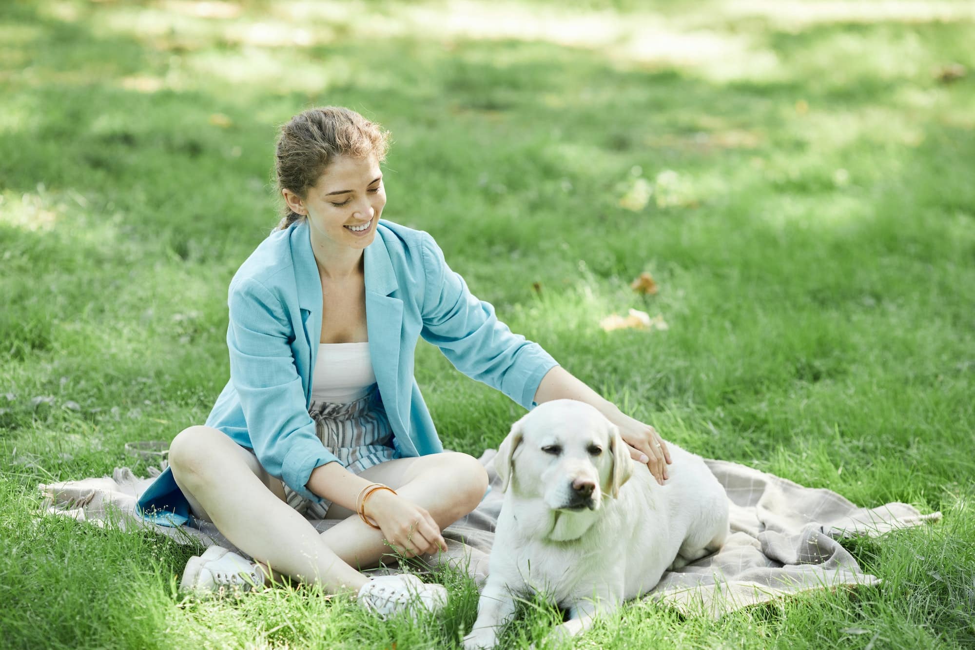 Young Woman Playing with Dog in Park